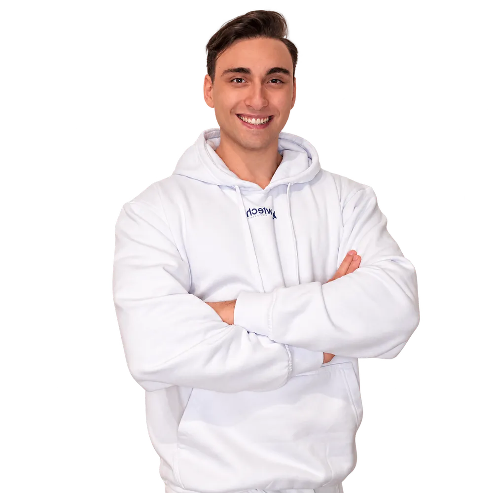 Antonio Ferone wearing a white Row Tech hoodie with his arms crossed